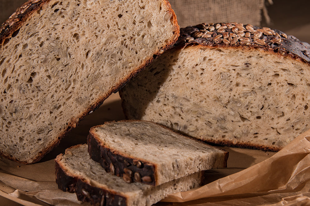 Seeded loaf, halved on a wooden board
